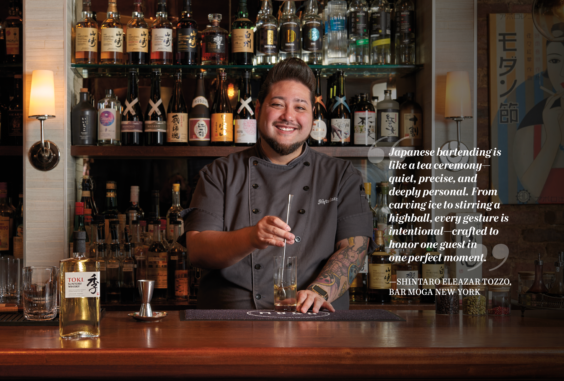 Image of SHINTARO ELEAZAR TOZZO in Bar Moga New York stirring a cocktail with quote "  Japanese bartending is like a tea ceremony: quiet, precise, and deeply personal. From carving ice to stirring a highball, every gesture is intentional— crafted to honor one guest in one perfect moment. " 